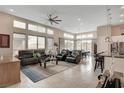 Bright and airy living room with large windows, tile floors, and a modern ceiling fan at 10985 Limeslice Ave # 2, Las Vegas, NV 89135
