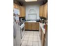Compact kitchen featuring tile floors, and light wood cabinets at 1407 Santa Margarita St # A, Las Vegas, NV 89146
