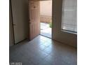 Bright living space with tiled flooring and entry to the front porch at 1608 N Torrey Pines Dr # 103, Las Vegas, NV 89108