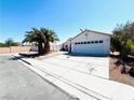 Charming single-story home with a well-maintained front yard, desert landscaping, and a two-car garage at 1860 Banaba Ln, Las Vegas, NV 89156