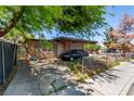 Charming single-story home features stone accents, a covered parking area, and mature landscaping at 201 Cervantes St, Las Vegas, NV 89101