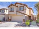 Inviting two-story house with desert landscaping and an attached two-car garage at 236 Dog Leg Dr, Las Vegas, NV 89148