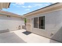 A private outdoor patio with a security gate offers a secure area to enjoy the outdoors at 2413 Mourning Warbler Ave, North Las Vegas, NV 89084