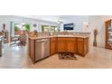 Open kitchen featuring granite counters, stainless steel appliances, and a breakfast bar at 2413 Mourning Warbler Ave, North Las Vegas, NV 89084