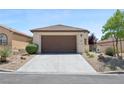 A well-maintained home featuring a two-car garage and desert landscaping at 2425 Sturrock Dr, Henderson, NV 89044