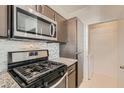 Well-equipped kitchen featuring stainless steel appliances and stylish backsplash at 251 S Green Valley Pkwy # 2821, Henderson, NV 89012