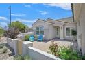 Inviting front patio with blue chairs and desert landscaping at 2601 Harrisburg Ave, Henderson, NV 89052