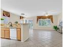 Spacious living area with tile flooring, granite counters, and lots of natural light at 2601 Harrisburg Ave, Henderson, NV 89052