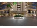 An entrance view of the Regency Towers building with palm trees and a circular garden at 3111 Bel Air Dr # 7F, Las Vegas, NV 89109