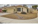 Stunning exterior view of single-story home showcasing desert landscaping, two-car garage and classic tile roofing at 3473 Conough Ln, Las Vegas, NV 89129