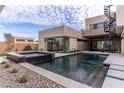 Backyard boasts a refreshing pool, spa, and sleek landscaping creating a private oasis at 3510 Cosima Ln, Las Vegas, NV 89120