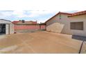 Spacious backyard with a covered patio, storage shed, and concrete paving at 411 Monmouth Ct, Henderson, NV 89015