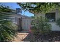 A private side yard enclosed by a secure gate and surrounded by mature landscaping at 4445 Peterson Dr, Las Vegas, NV 89103