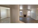 Bright living room featuring neutral paint, fireplace, and wood flooring at 4555 Sahara Ave # 252, Las Vegas, NV 89104
