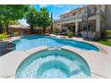 Relax in the inviting pool and spa, complete with lounge chairs and a soothing waterfall feature at 5186 San Milano Ave, Las Vegas, NV 89141