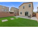 Spacious backyard with artificial turf, brick patio and plenty of space for outdoor entertaining at 5255 Peak Rock Ct, Las Vegas, NV 89141
