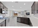 Bright open kitchen boasts stainless appliances, mosaic backsplash, and connects to dining and living areas at 5255 Peak Rock Ct, Las Vegas, NV 89141