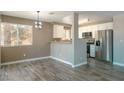 Kitchen and dining area with stainless steel appliances, updated light fixture and lots of natural light at 6873 Tamarus St # 201, Las Vegas, NV 89119