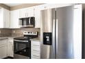 Updated kitchen boasts stainless steel appliances and granite countertops at 6873 Tamarus St # 201, Las Vegas, NV 89119