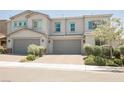Charming two-story townhome featuring a neutral color palette and manicured landscaping at 7002 Fossil Rim St, North Las Vegas, NV 89084