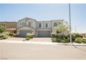 Charming two-story townhome featuring a neutral color palette and manicured landscaping at 7002 Fossil Rim St, North Las Vegas, NV 89084