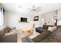 Cozy living room featuring a ceiling fan, comfortable seating, and ample natural light at 7002 Fossil Rim St, North Las Vegas, NV 89084