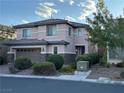 Two-story home with desert landscaping, a brick driveway, and stone accents on the facade at 7325 Perkins Hill St, Las Vegas, NV 89166