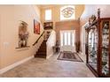 Grand foyer featuring high ceilings, elegant chandelier, and staircase at 7718 Willow Cove Cir, Las Vegas, NV 89129