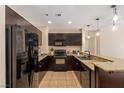 Well-equipped kitchen with black appliances, granite counters and sleek, dark cabinetry at 8255 Las Vegas Blvd # 117, Las Vegas, NV 89123