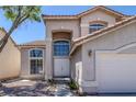 Inviting two-story home featuring manicured desert landscaping and a two car garage at 829 Dancing Vines Ave, Las Vegas, NV 89183