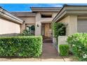 Close-up of the front entrance with an ornate security gate and manicured hedges for added privacy at 9921 Mirada Dr, Las Vegas, NV 89144