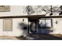 Two story residential building with neutral stucco exterior with dark trim, a front door, and small landscaped front yard at 1336 N Jones Blvd, Las Vegas, NV 89108