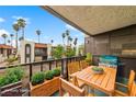 Private balcony perfect for outdoor dining and relaxation with views of tropical trees and neighboring buildings at 1405 Vegas Valley Dr # 98, Las Vegas, NV 89169