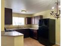 Cozy kitchen with dark cabinets, light countertops, and black appliances at 1505 Frank Aved St # 101, Las Vegas, NV 89110