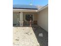 Inviting home featuring desert landscaping, a covered porch, and solar panels on the roof at 1611 Red Rock Dr, Pahrump, NV 89048