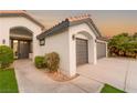 Home exterior showcasing front entrance, two car garage, desert landscaping at 1616 Shadow Rock Dr, Las Vegas, NV 89117