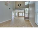 Spacious living room featuring tile floors, high ceilings, and large windows for plenty of natural light at 1917 Badger Canyon Ave, North Las Vegas, NV 89031