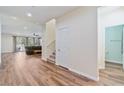 Bright living room with wood floors, large windows, and a sliding glass door at 2037 Brush Stroke St, Henderson, NV 89044