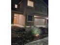 Well-lit, two-story house boasting a two-car garage and manicured rock garden at 2077 Alki Beach Ave, Laughlin, NV 89029