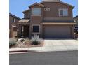 Beautiful two-story home with a two-car garage and tidy landscaping at 2077 Alki Beach Ave, Laughlin, NV 89029
