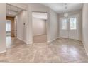 Bright foyer showcasing tile flooring, an elegant chandelier, and views into adjacent living spaces at 2114 Twin Falls Dr, Henderson, NV 89044