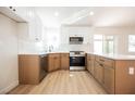 Updated kitchen boasts stainless steel appliances, modern cabinetry, and stylish countertops at 2719 Frangipani Ct, North Las Vegas, NV 89031