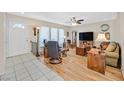 Inviting living room with hardwood flooring, bright windows, and an open floor plan at 3753 Heritage Ave, Las Vegas, NV 89121
