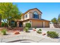 Charming two-story home with a spacious three-car garage and mature desert landscaping enhancing curb appeal at 419 Alonzo Ct, Las Vegas, NV 89123
