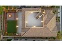 Aerial view of a home with a tile roof, outdoor fire pit, patio, and low-maintenance landscaping at 424 Vigo Port St, Las Vegas, NV 89138