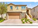 Charming two-story home with a two-car garage, stone accents, landscaped yard, and covered entryway at 424 Vigo Port St, Las Vegas, NV 89138