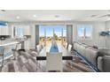 Open concept living room with wood floors, dining table, and large windows showing scenic views at 424 Vigo Port St, Las Vegas, NV 89138