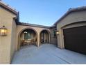 Covered front entrance featuring a sitting area and direct access to the three car garage at 4242 Helena Hideaway Ct, Las Vegas, NV 89129