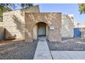 Charming front entrance with an arched entryway, stucco walls, and low maintenance landscaping at 45 N Lamb Blvd, Las Vegas, NV 89110