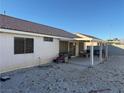 Spacious backyard featuring a covered patio area, low-maintenance gravel, and block wall fencing at 4636 Ferrell St, North Las Vegas, NV 89031